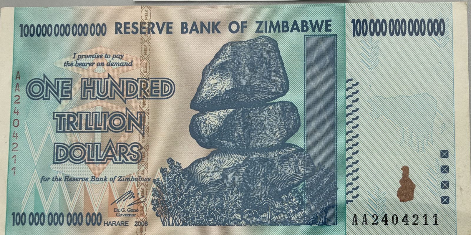 Front of a 2008 Reserve Bank of Zimbabwe one hundred trillion dollar banknote showing the Chiremba balancing rocks